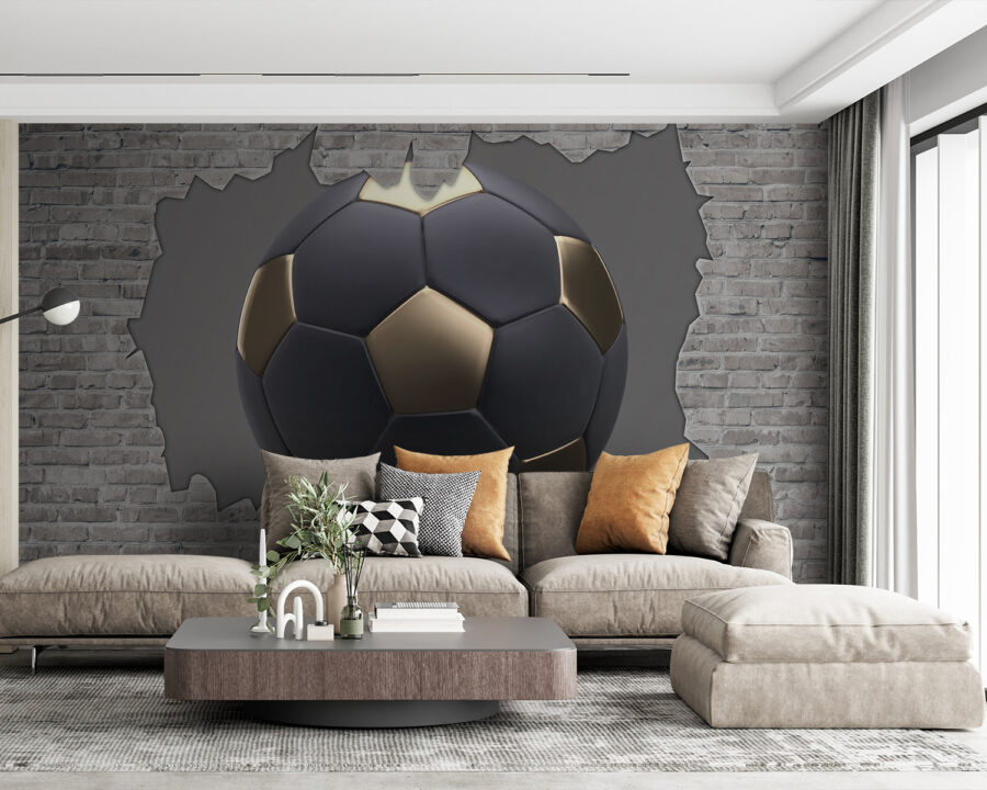 Ballon de football noir et or dans un trou dans un mur de briques