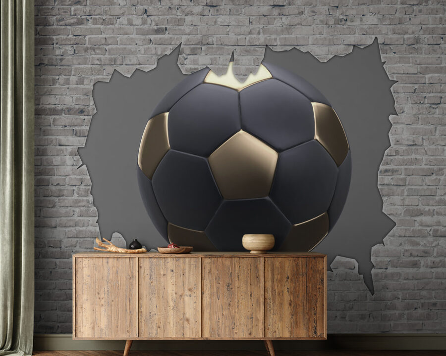 Ballon de football noir et or dans un trou dans un mur de briques