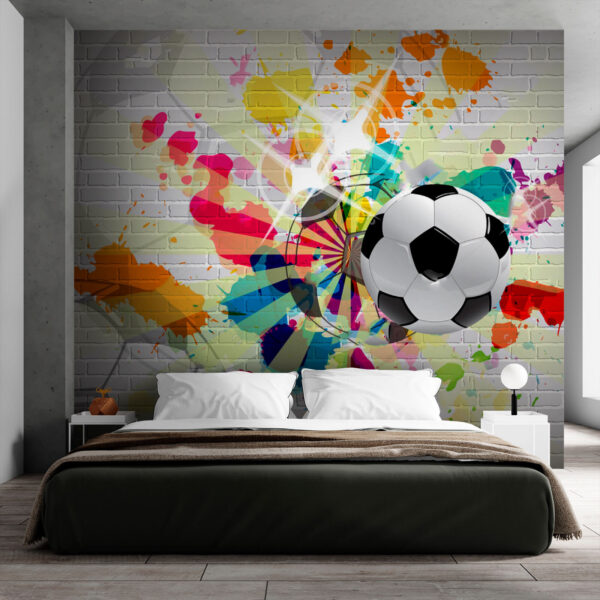 Ballon de football sur un mur de briques Ballon de football sur un mur de briques