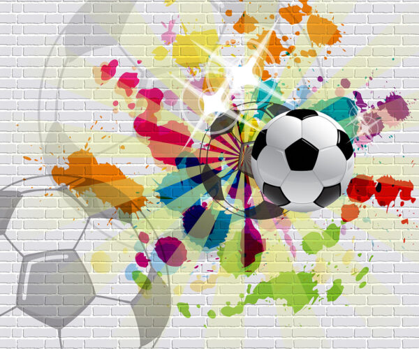 Ballon de football sur un mur de briques Ballon de football sur un mur de briques