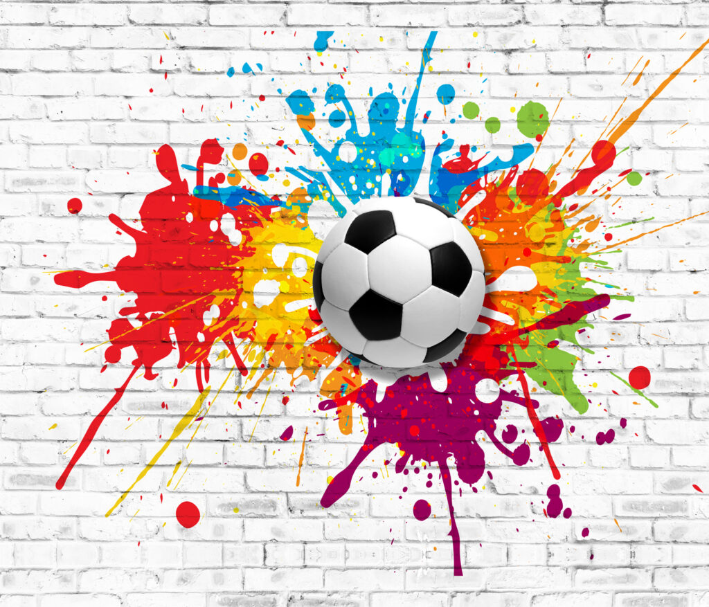Ballon de football sur un mur de briques Ballon de football sur un mur de briques