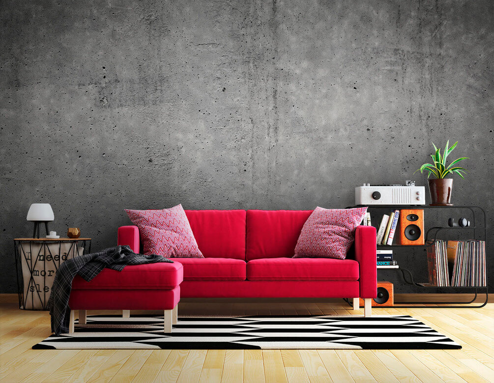 Grey concrete wall with black spots