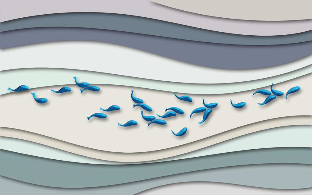 Groupe de poissons bleus nageant dans un groupe de vagues Groupe de poissons bleus nageant dans un groupe de vagues