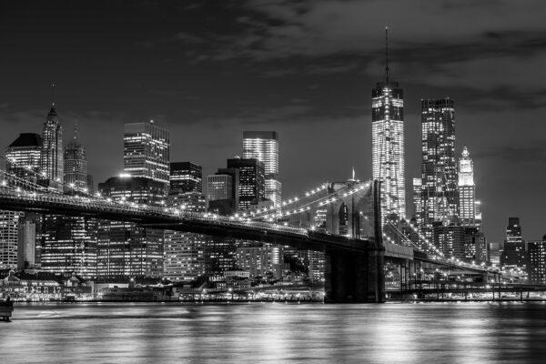 Pont au-dessus de l'eau avec la ligne d'horizon de la ville la nuit Pont au-dessus de l'eau avec la ligne d'horizon de la ville la nuit