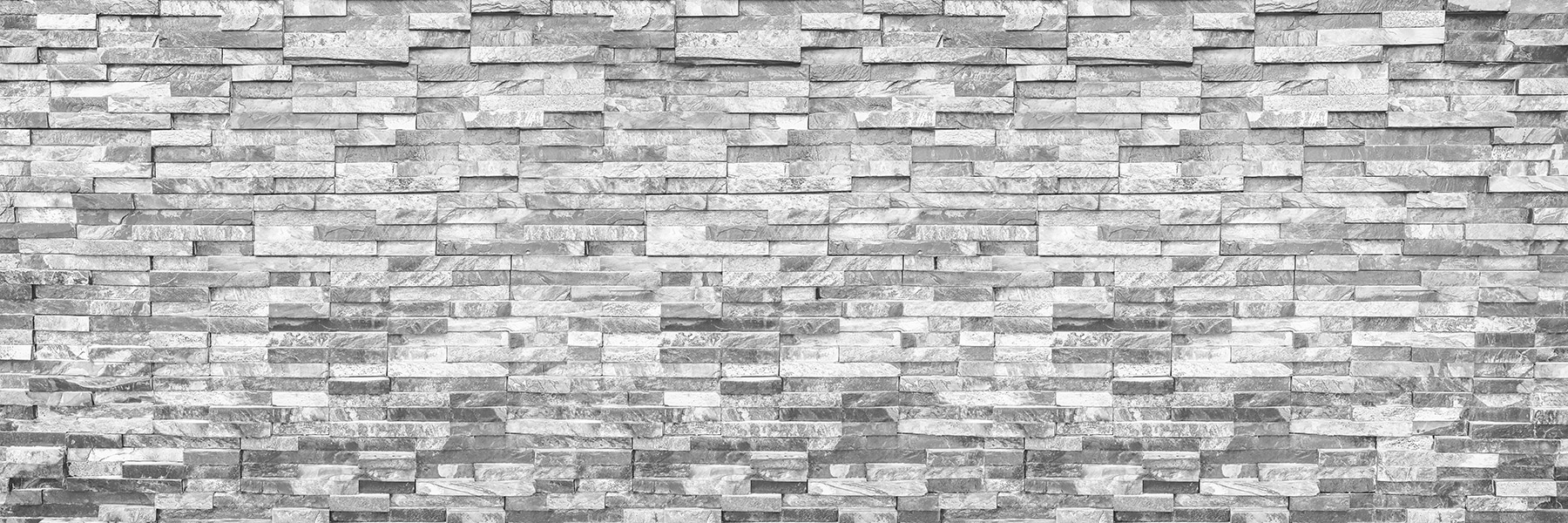 Textured stone wall in monochrome design Textured stone wall in monochrome design