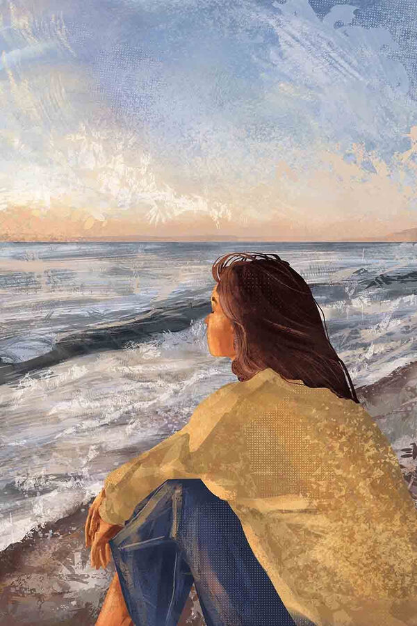Une femme assise sur une plage regardant l'océan Une femme assise sur une plage regardant l'océan