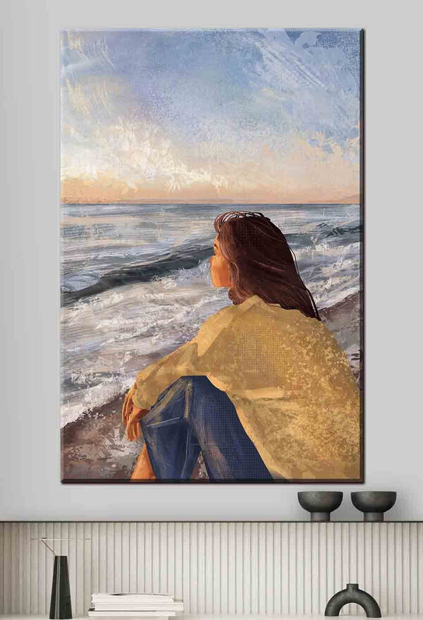 Une femme assise sur une plage regardant l'océan Une femme assise sur une plage regardant l'océan