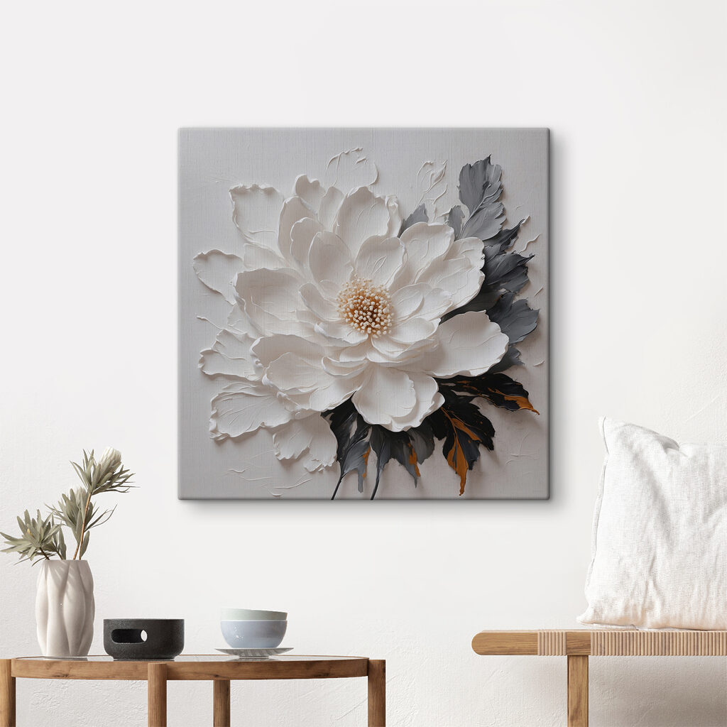 A white flower with black and grey leaves