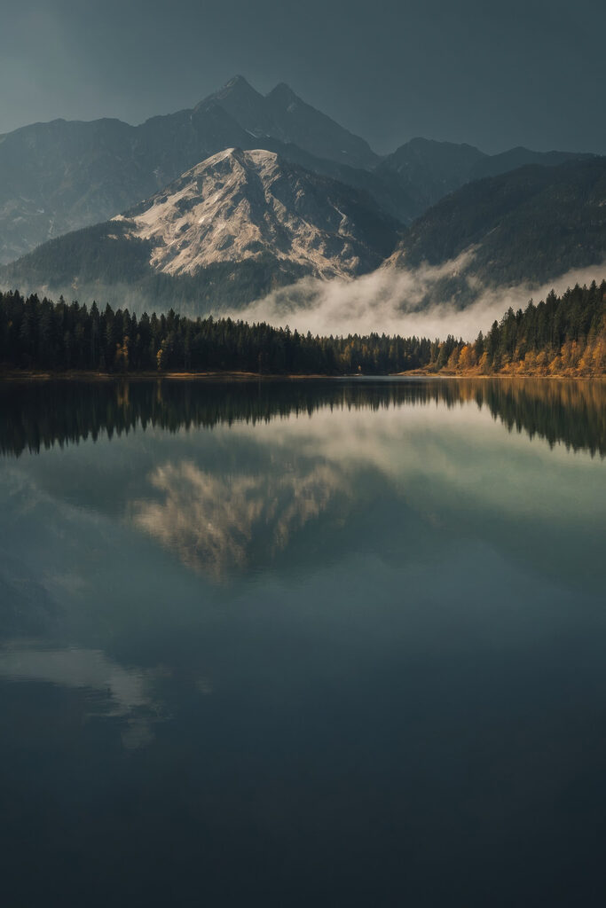 Lake with trees and mountains in the background Lake with trees and mountains in the background