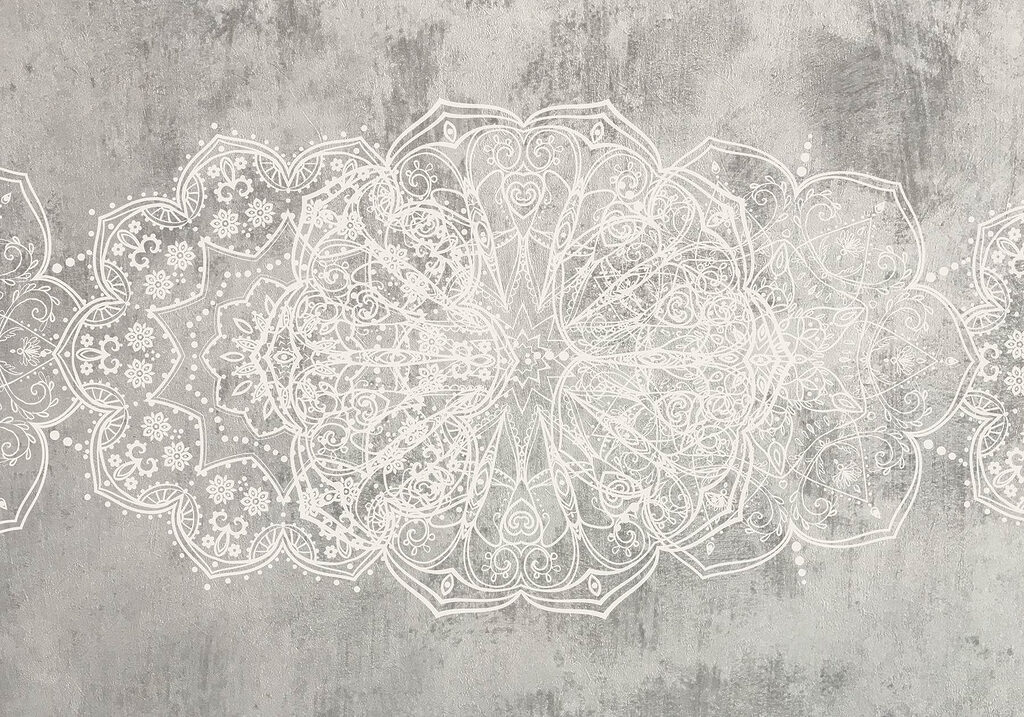 Motif orné blanc sur une surface grise Motif orné blanc sur une surface grise