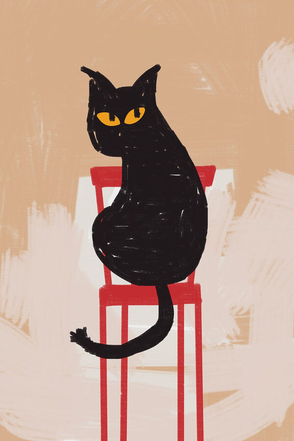 Chat noir assis sur une chaise rouge Chat noir assis sur une chaise rouge
