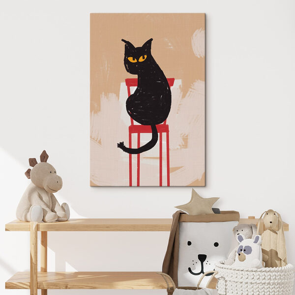 Chat noir assis sur une chaise rouge Chat noir assis sur une chaise rouge