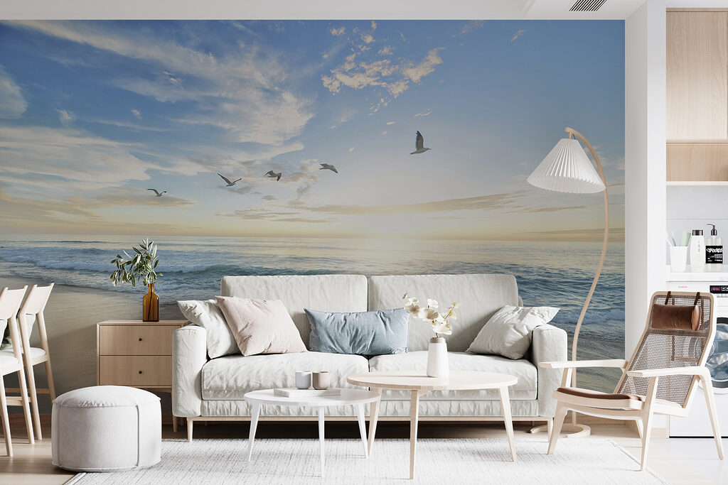 Beach with birds flying over the water