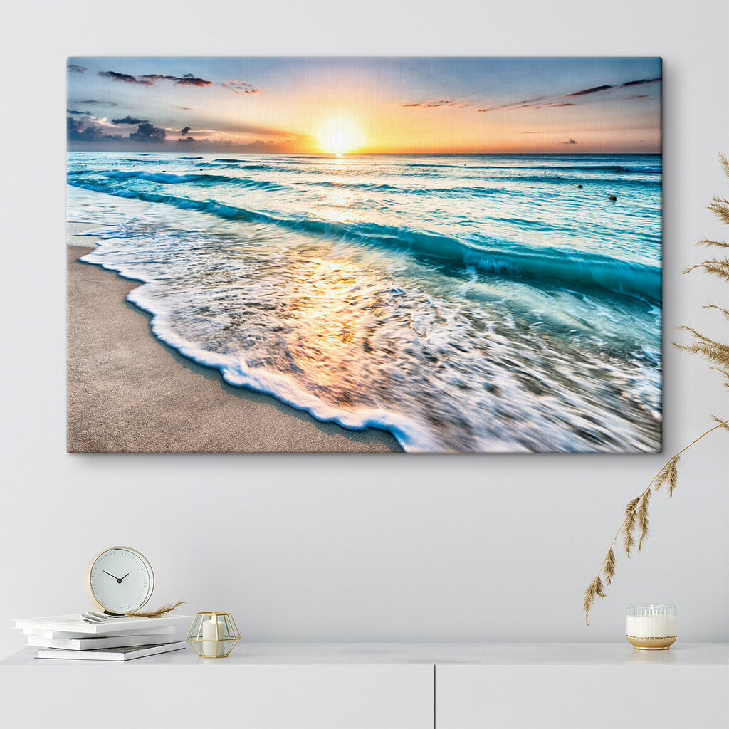 A beach with waves and a sunset