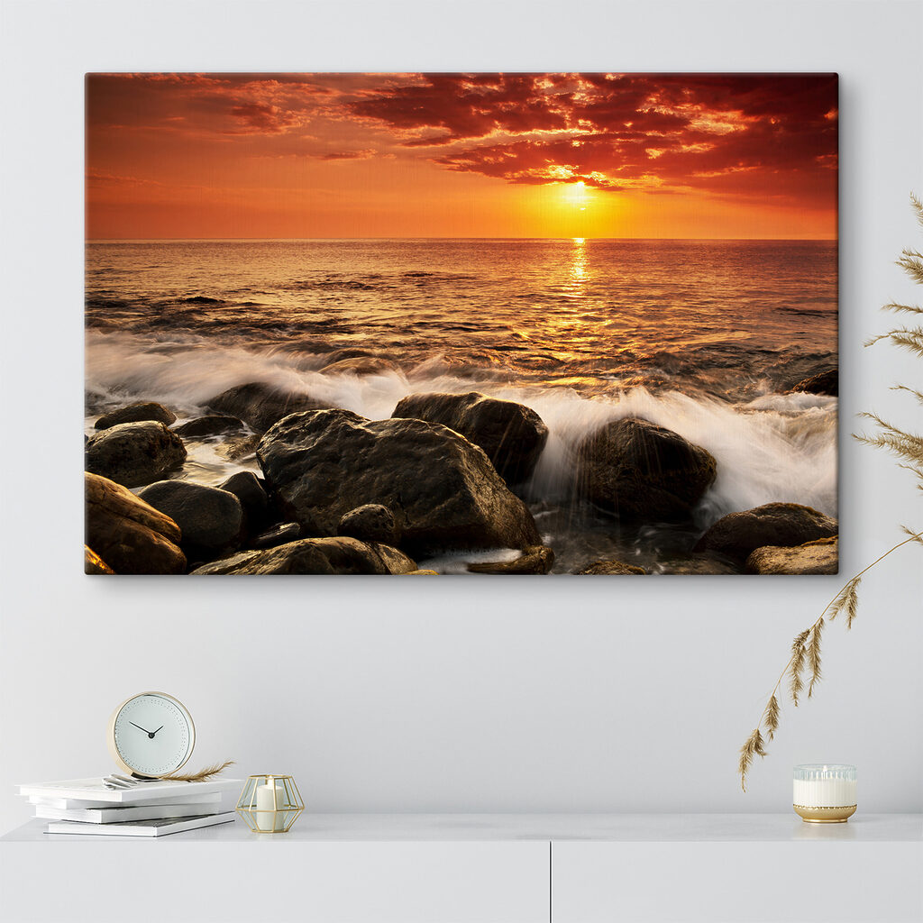 A sunset over a rocky beach