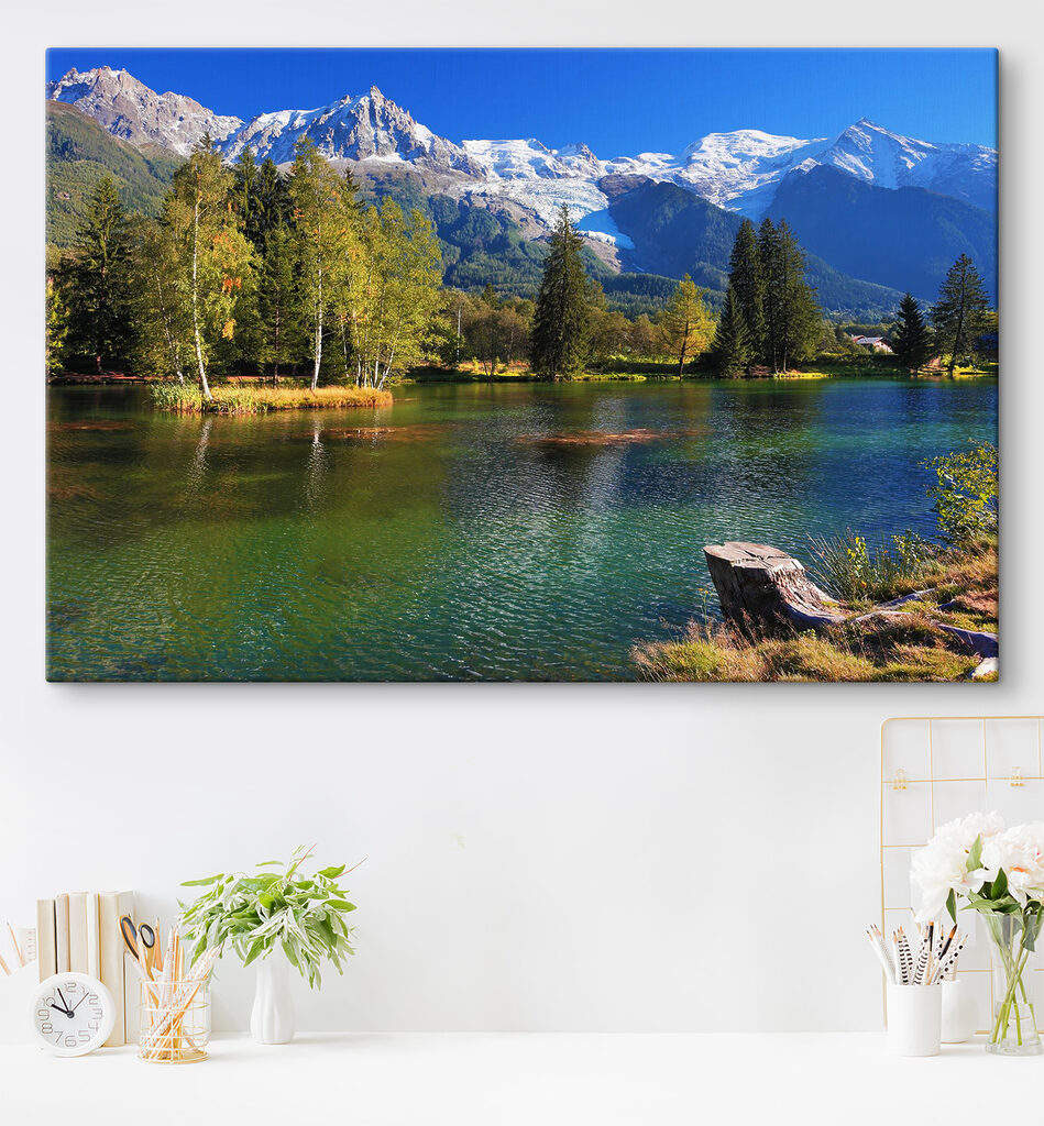 A lake surrounded by trees and mountains A lake surrounded by trees and mountains