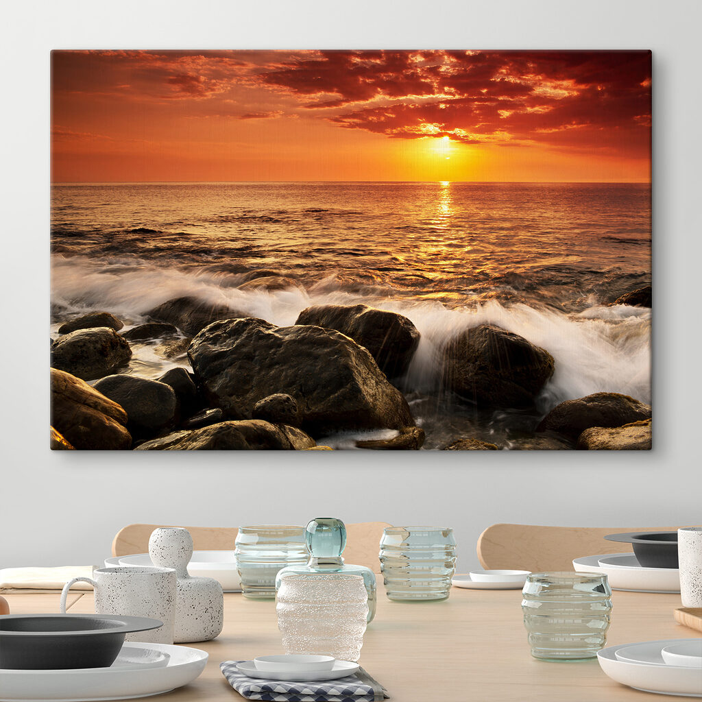 A sunset over a rocky beach