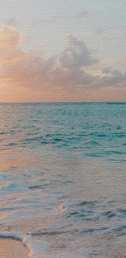 A beach with waves and a sunset