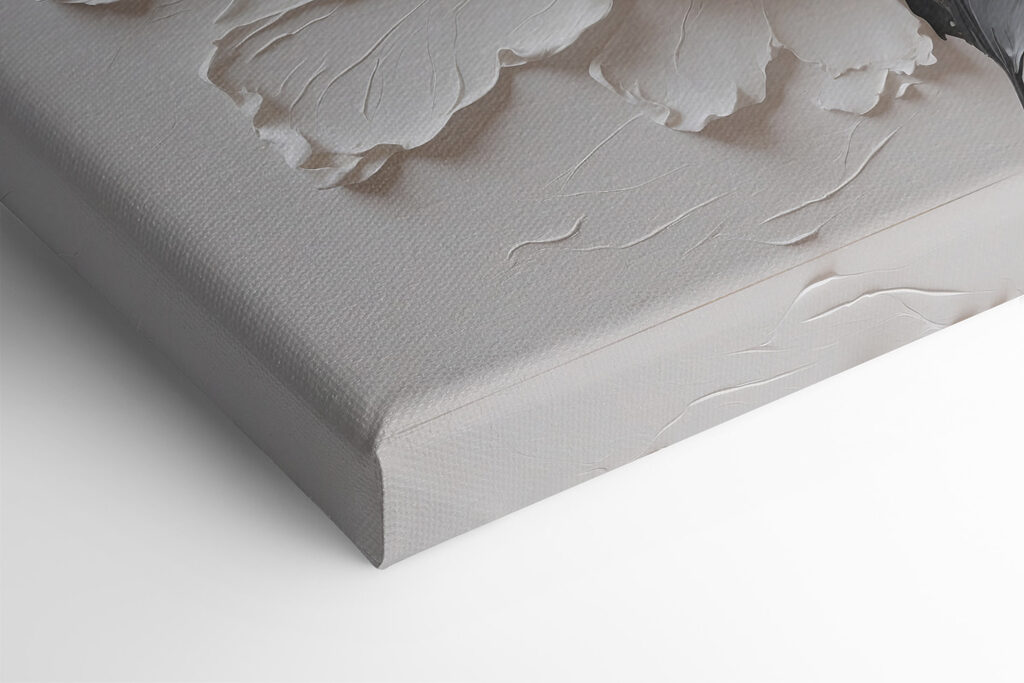 A white flower with black and grey leaves