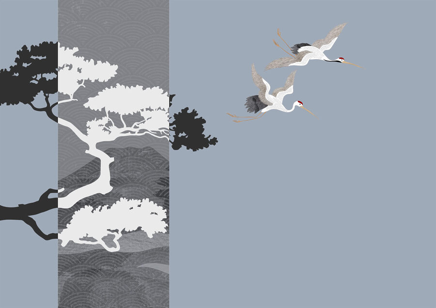 Couple de grues volant près d'un arbre