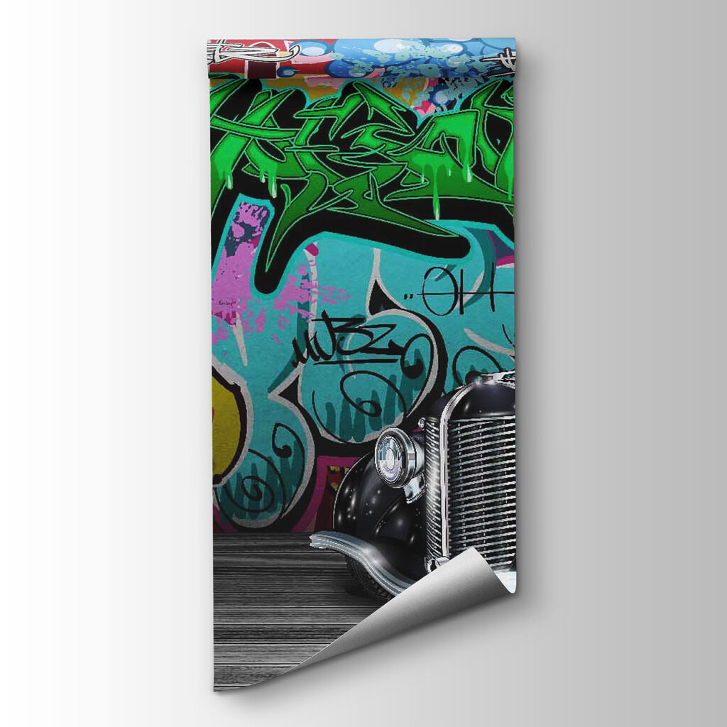 Black car with wheels in front of a colorful wall