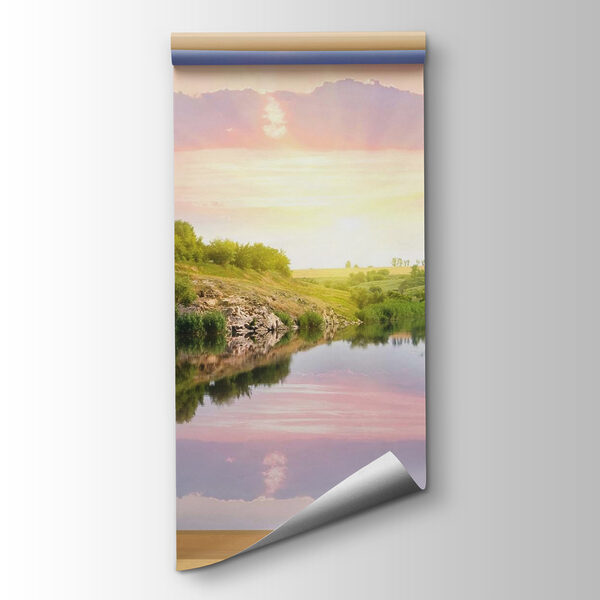 Window with a view of a river and a grassy hill