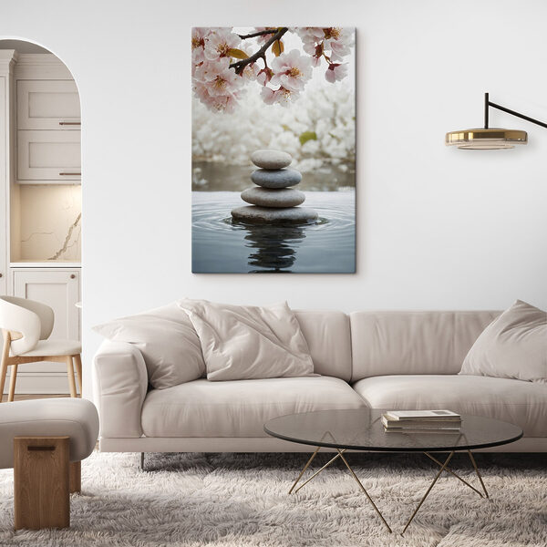 Stack of rocks in water with flowers in the background