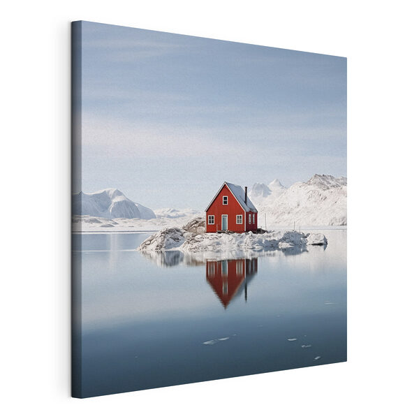 Red house on an island in water with snow covered mountains in the background